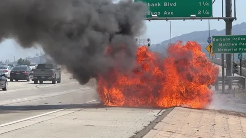 Burning car on fire explosion on freeway Stock Footage 283623090