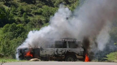 Burning car in the middle of nature Stock Footage 56320989