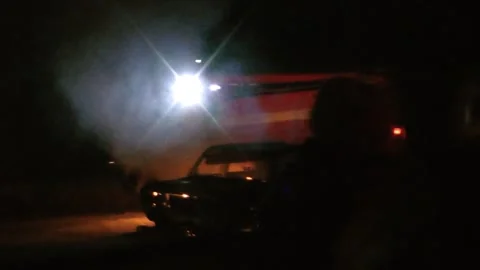Burning car at night and fire truck Stock Footage 273203773