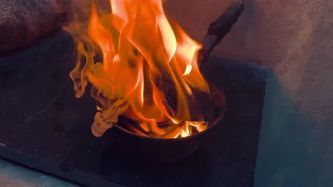 Burning charcoal with flames of fire of a superstitious ritual Stock Footage 202645450