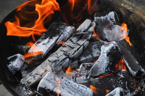 Burning charcoal inside a grill Stock Photos