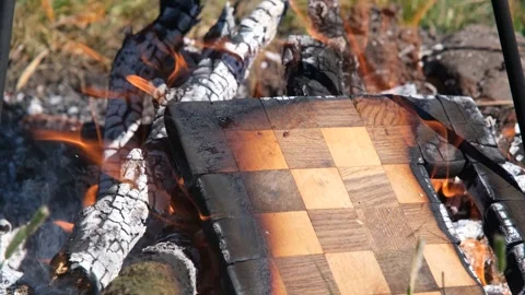 Burning chessboard. The chessboard is burning in the fire. Chessboard on fire Stock Footage 279271415