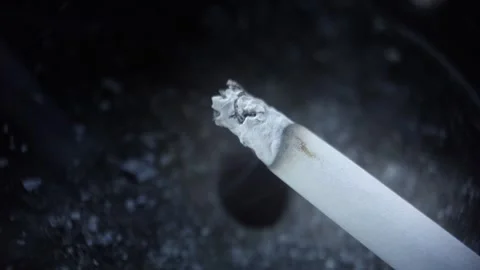 Burning cigarette in a ashtray Stock Footage 312633140
