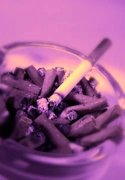 BURNING CIGARETTE IN ASHTRAY Stock Photos