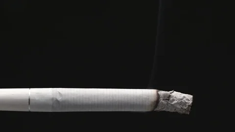 Burning cigarette on a black background close-up. Timelapse video footage Stock Footage 123800456