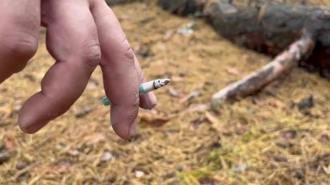 Burning cigarette in hand Stock Footage 279297794