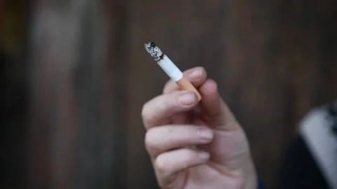 Burning cigarette in hand. Video stock 300370715