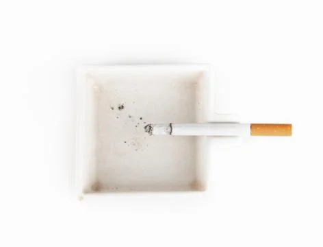 A burning cigarette in a white ashtray studio isolated on white Stock Photos