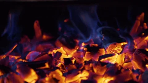 Burning coal. Close up of red hot coal burning in a stove. Slow motion Stockbeeldmateriaal 80523841
