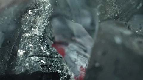Burning coal with drifting ash. Glowing red embers shine through cracks in coal Stock Footage 335770863