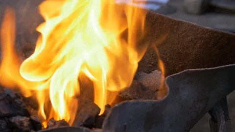 Burning coal in the hearth of a blacksmith Video stock 79694167