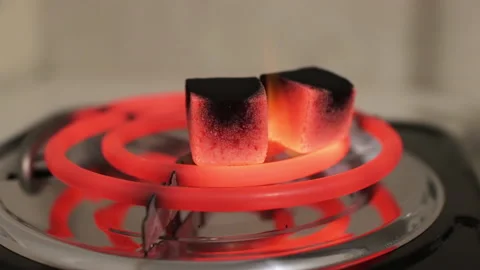 Burning coal for hookah on special professional stove. Preparing shisha at home Stock Footage 167458228