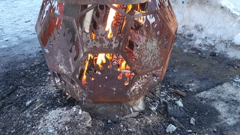 Burning coals in a brazier. Maslenitsa celebration in the city park. Stock Footage 304118239