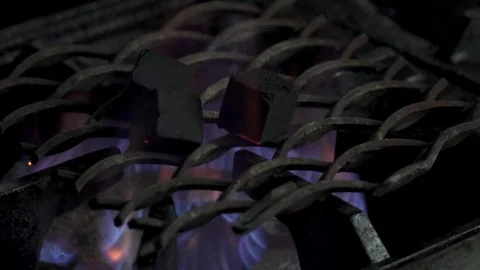 Burning coals for hookah in the kitchen closeup, slow motion Stock Footage 73619952