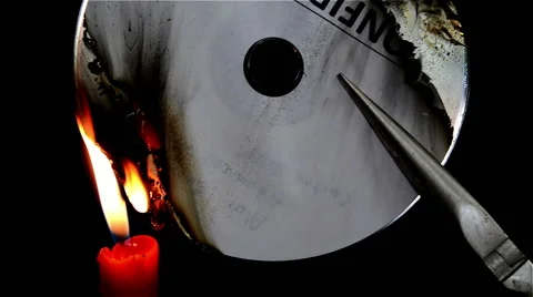 Burning a compact disc with candle Stock Footage 59999168