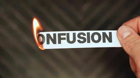 Burning “confusion” label held by hand, symbolizing mental clarity, clear Stock Footage 333655287