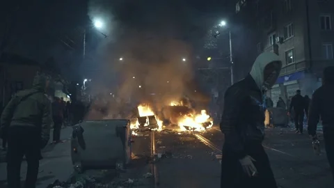 Burning containers set by hooligans on a night boulevard in Sofia Stock Footage 324559586