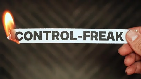 Burning “control-freak” label held by hand, symbolizing trust, flexibility Stock Footage 333655554