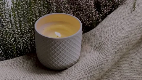 A burning decorative candle in a ceramic jar Stock-Footage 164746479