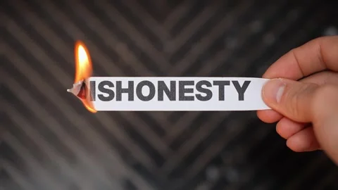 Burning “DISHONESTY” concept symbolizing truth, integrity, transparency, and Stock Footage 333655444