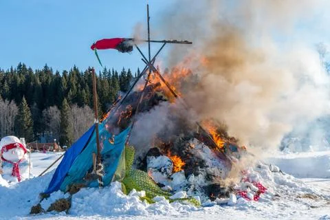 Burning down straw effigy at Maslenitsa festival with visible framework Stock Photos