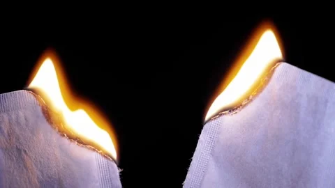 Burning Edges Of White Paper Sheets Against A Black Background Stock Footage 330301153