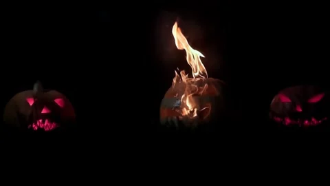 Burning evil pumpkin being smashed with a tapor, slow motion Stock Footage 251855299