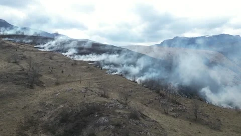 Burning field. Firemen approaching the fire. Wildfire in the mountains. Stock Footage 270208752
