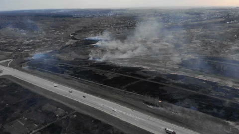 Burning fields near the highway. Stock Footage 106376815