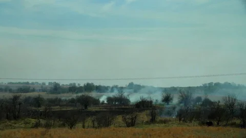 Burning Fields While Driving on American Highway Stock Footage 128755855