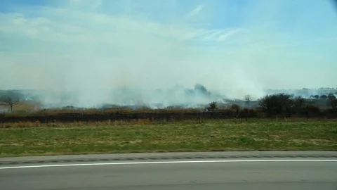 Burning Fields While Driving on American Highway Stock Footage 128755936