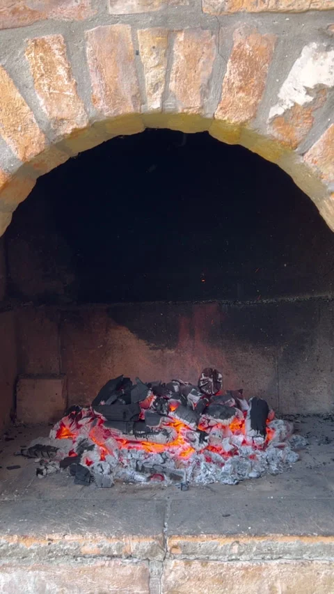 Burning fire and charcoal in brick barbecue fireplace Video stock 240434079