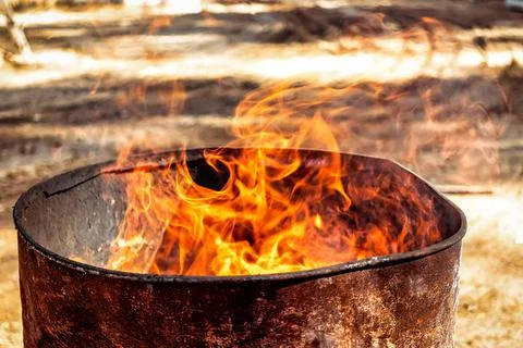 Burning fire in a barrel close-up. Bright flame. Open flame heating. Problems Photos