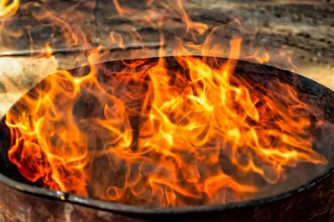 Burning fire in a barrel close-up. Bright flame. Open flame heating. Problems Stock Photos