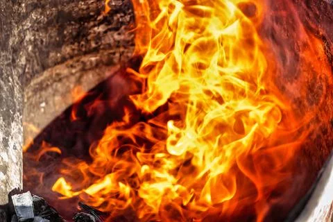 Burning fire close up. Bright orange and red flames on a dark background. Ope Photos