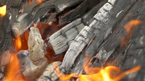 Burning fire, the coal is stirred around with a fireplace poker. Stock Footage 136721161