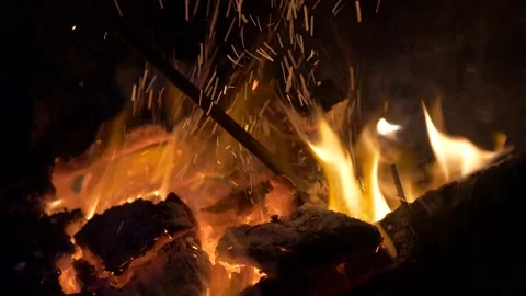 Burning fire, the coal is stirred around with a fireplace poker. Stock Footage 136722445