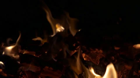 Burning fire, the coal is stirred around with a fireplace poker. Stock Footage 137568883