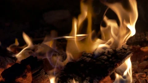 Burning fire, the coal is stirred around with a fireplace poker. Stock Footage 137569664