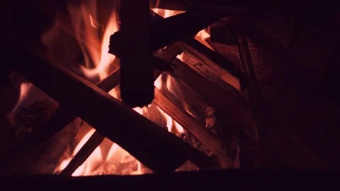 Burning fire in the fireplace flame covers firewood Stock Footage 187737428