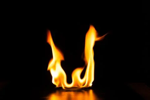 Burning fire flame on black background Stock Photos