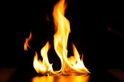 Burning fire flame on black background Stock Photos