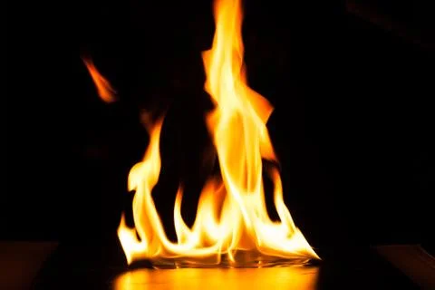 Burning fire flame on black background Stock Photos