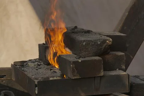A burning fire in a forge for forging iron products. Stock Photos