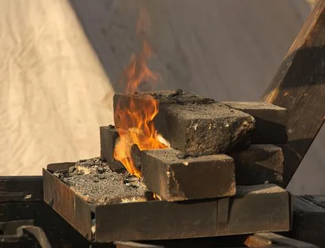 A burning fire in a forge for forging iron products. Stock Photos
