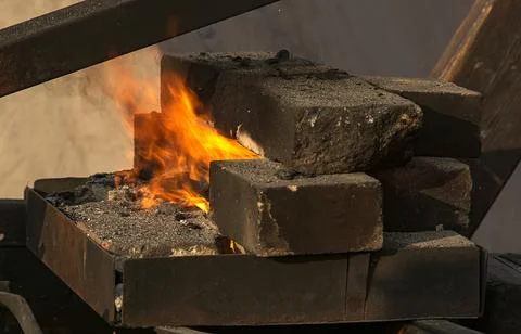 A burning fire in a forge for forging iron products. Stock Photos