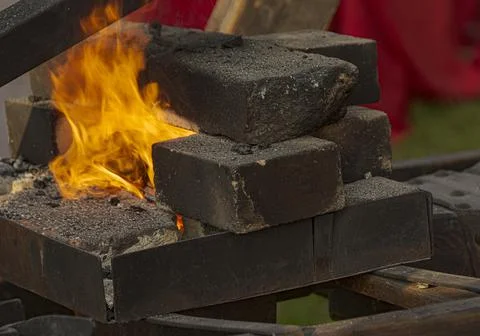 A burning fire in a forge for forging iron products. Stock Photos