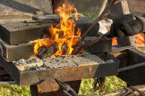 A burning fire in a forge for forging iron products. Stock Photos