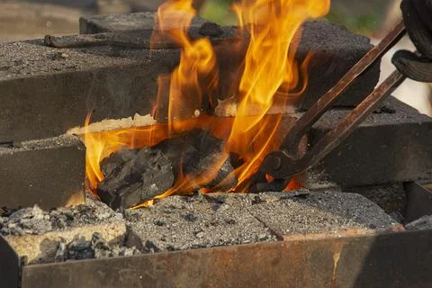 A burning fire in a forge for forging iron products. Stock Photos