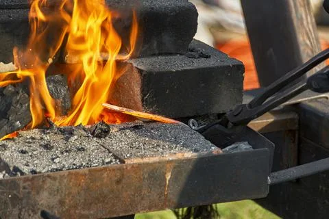 A burning fire in a forge for forging iron products. Stock Photos
